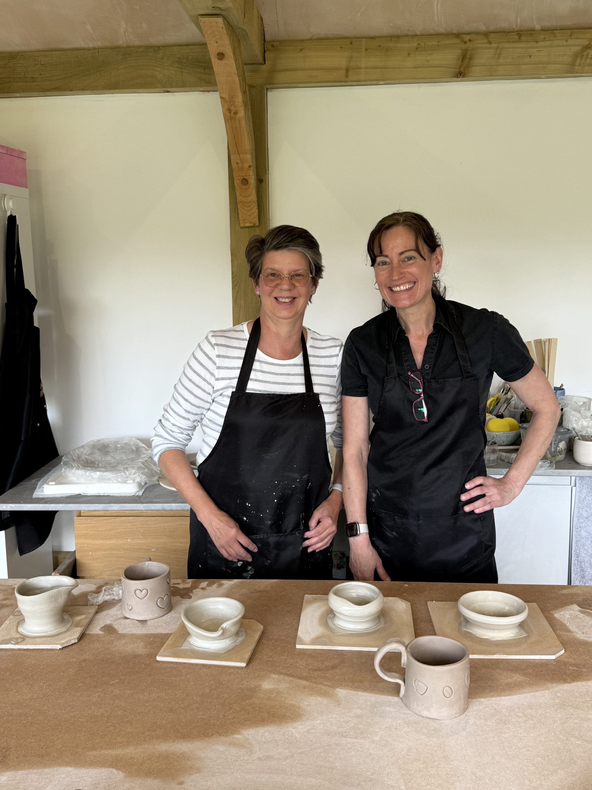 2 people pictured in a pottery studio